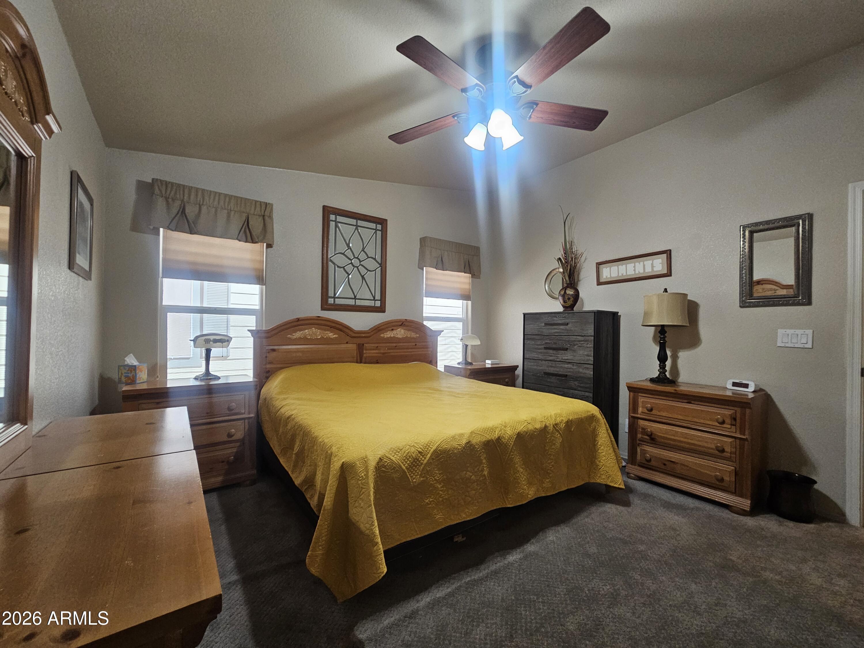 650 North Hawes Road, Unit 4410 Mesa, AZ 85207 - Photo 19 of 40 a spacious bedroom with a bed and a chandelier
