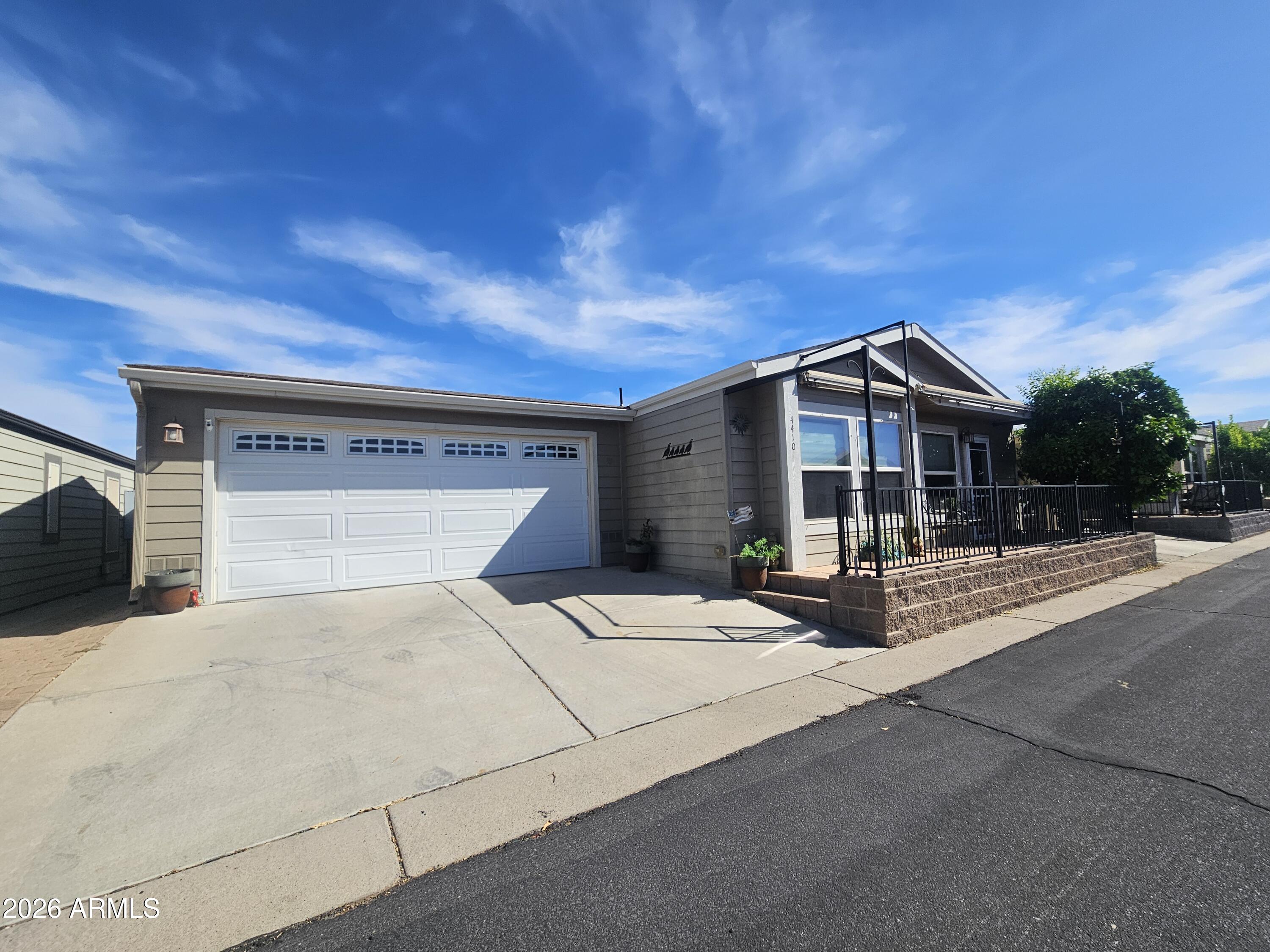 650 North Hawes Road, Unit 4410 Mesa, AZ 85207 - Photo 2 of 40 a front view of house with yard and trees in the background