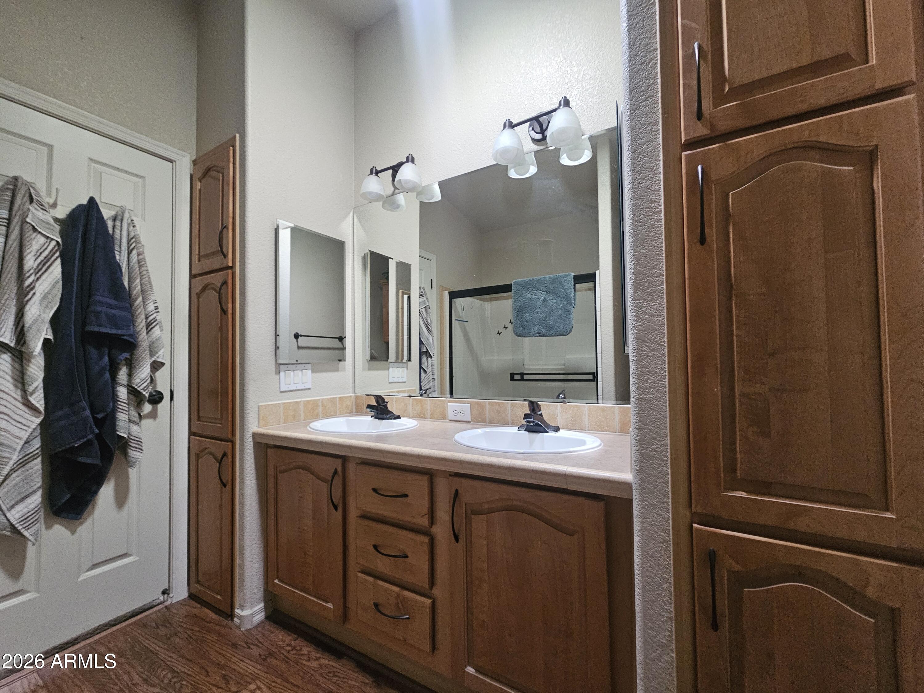 650 North Hawes Road, Unit 4410 Mesa, AZ 85207 - Photo 23 of 40 a bathroom with a double vanity sink and mirror
