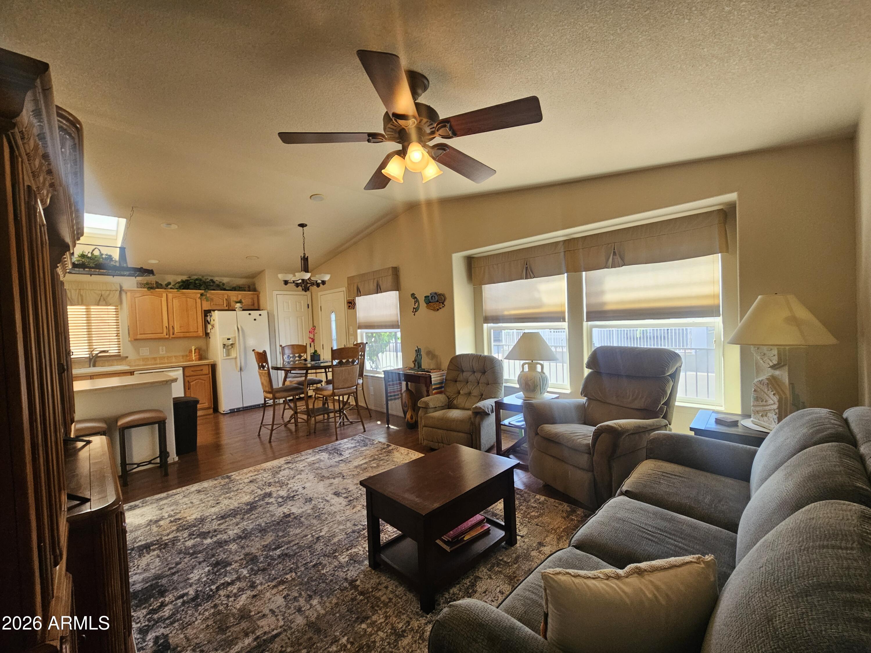 650 North Hawes Road, Unit 4410 Mesa, AZ 85207 - Photo 3 of 40 a living room with furniture ceiling fan and a window