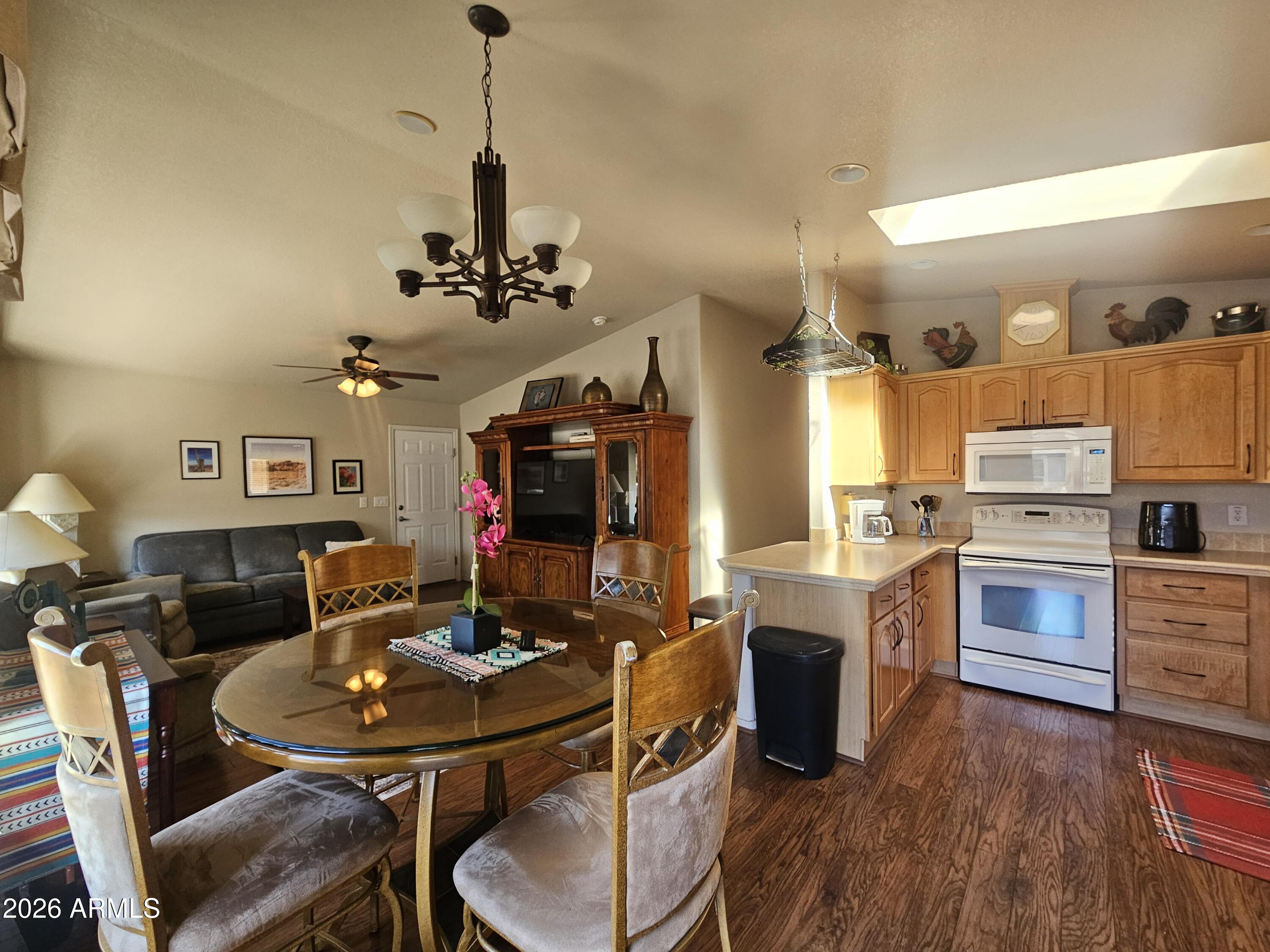 650 North Hawes Road, Unit 4410 Mesa, AZ 85207 - Photo 4 of 40 a view of a dining room with furniture and wooden floor