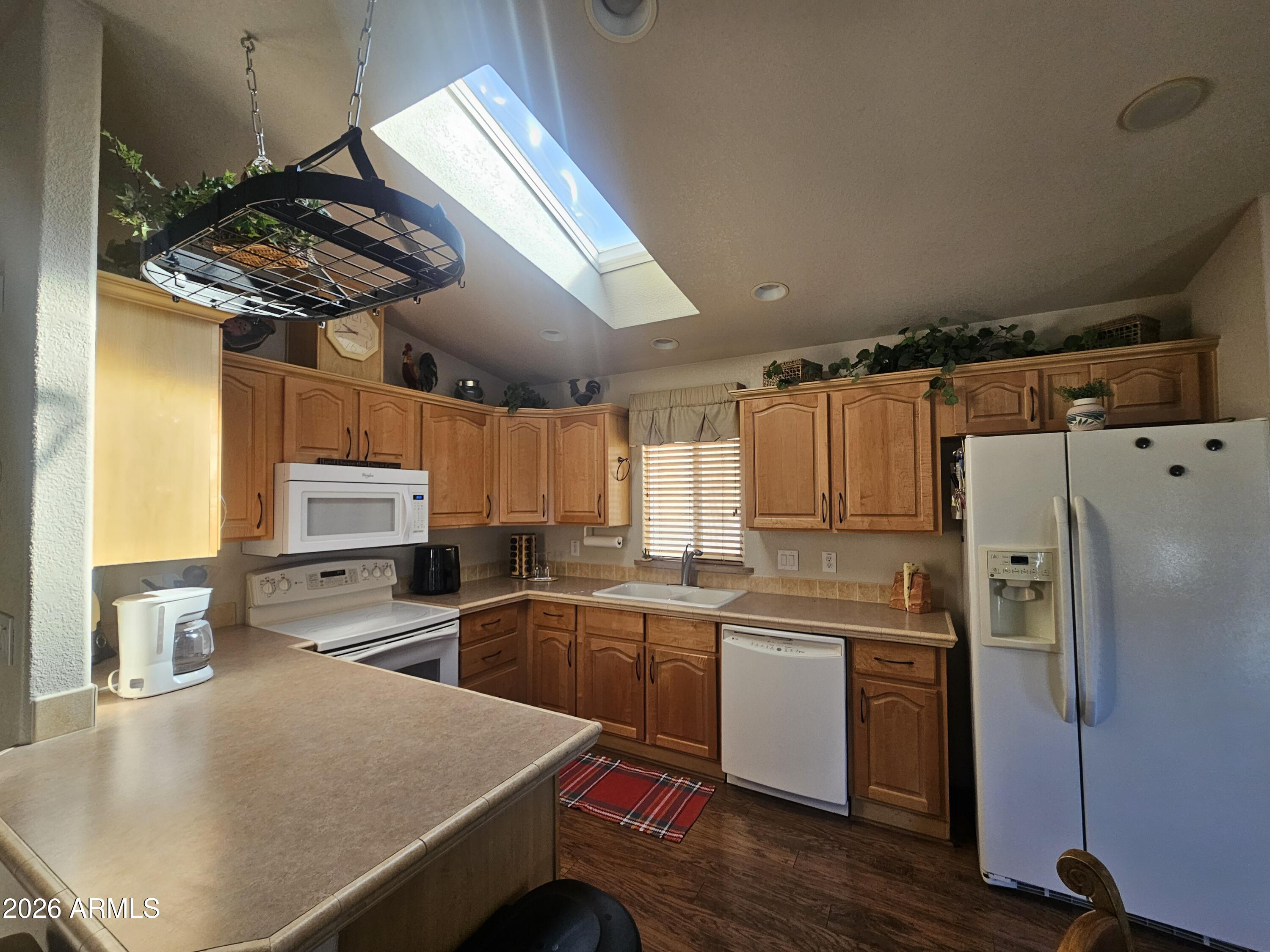 650 North Hawes Road, Unit 4410 Mesa, AZ 85207 - Photo 5 of 40 a kitchen with stainless steel appliances a sink a stove a refrigerator cabinets and wooden floor