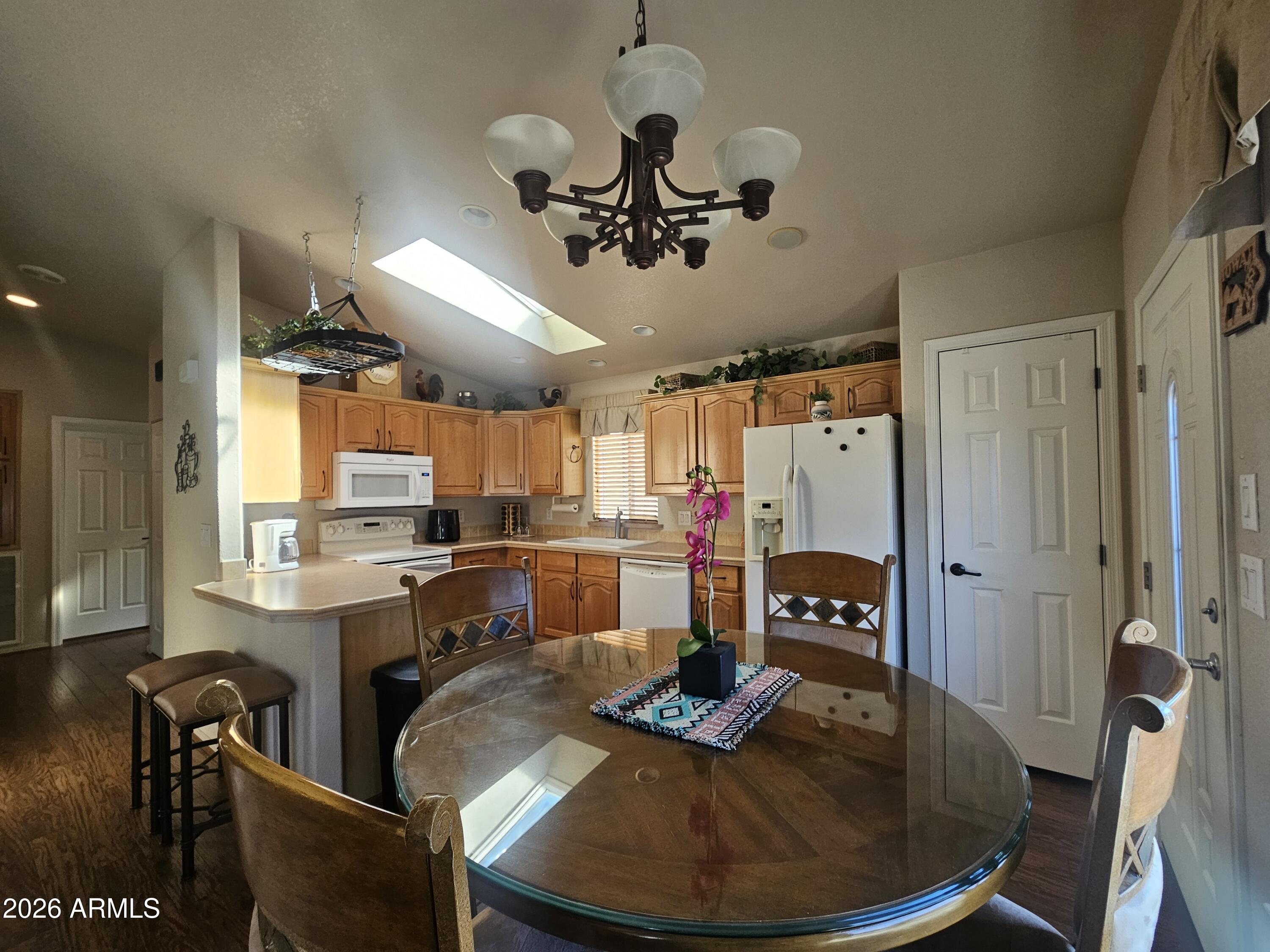 650 North Hawes Road, Unit 4410 Mesa, AZ 85207 - Photo 6 of 40 a view of a dining room with furniture window and wooden floor