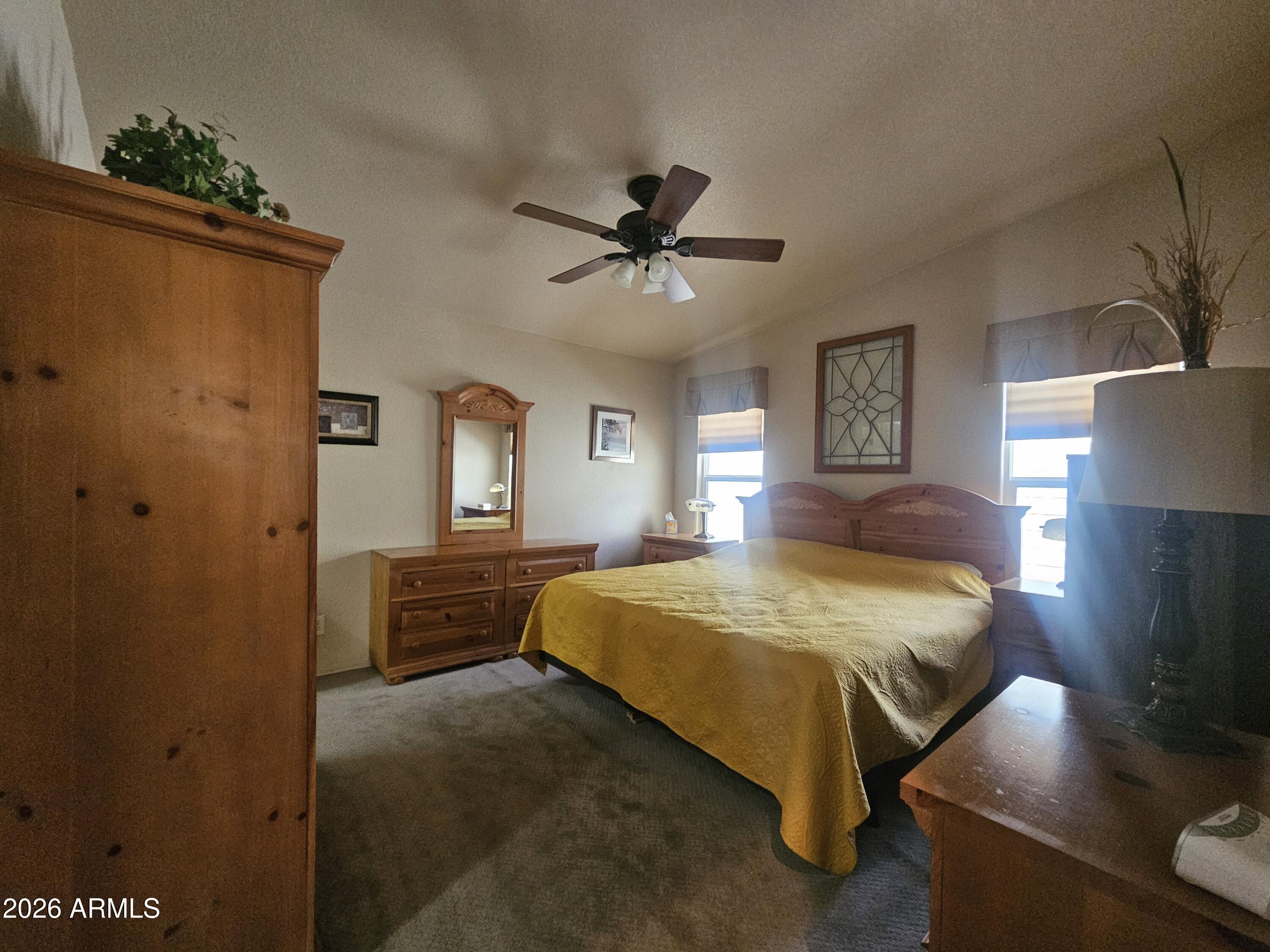 650 North Hawes Road, Unit 4410 Mesa, AZ 85207 - Photo 7 of 40 a spacious bedroom with a bed and a chandelier