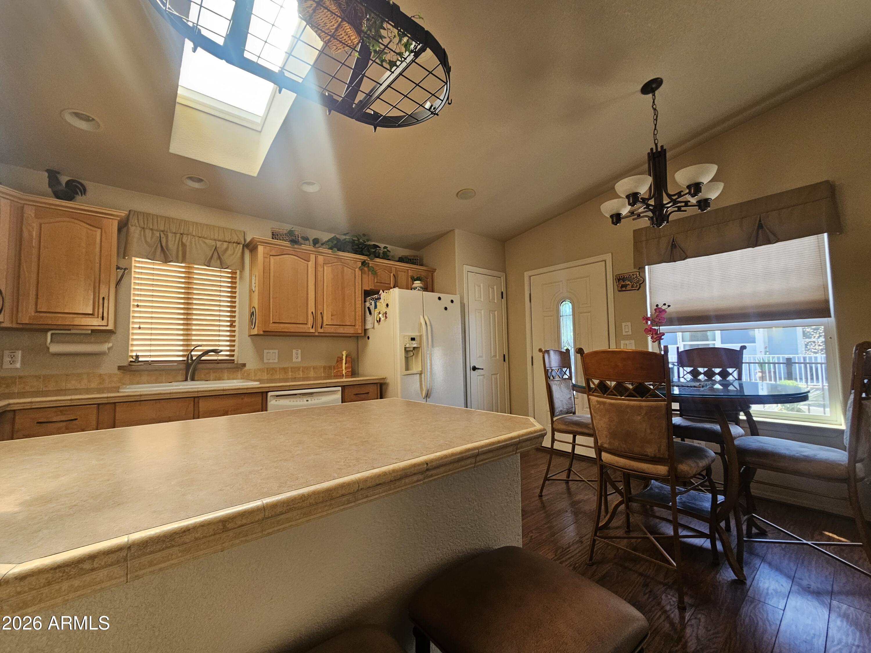 650 North Hawes Road, Unit 4410 Mesa, AZ 85207 - Photo 8 of 40 a view of a dining room with furniture window and wooden floor