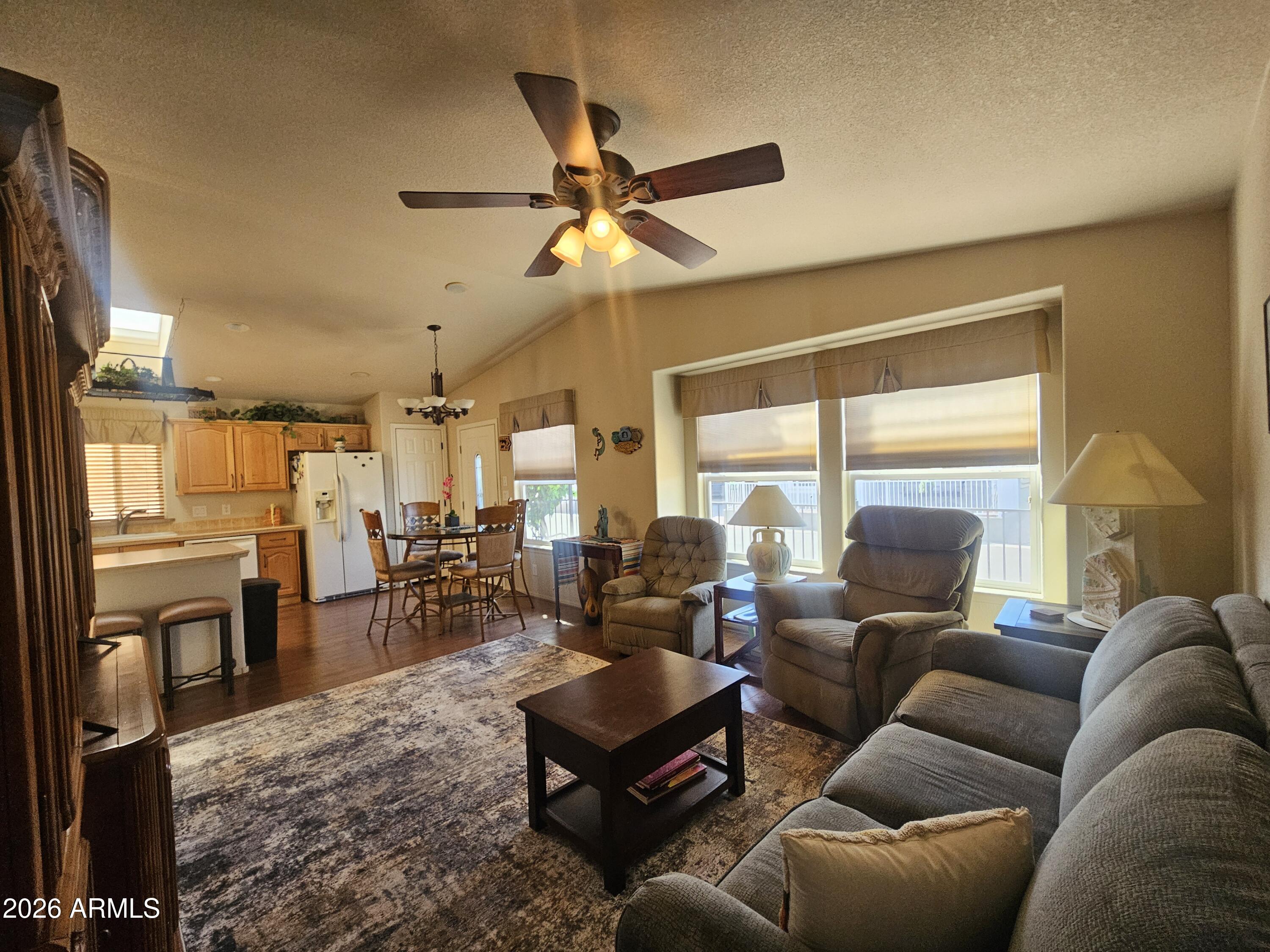 650 North Hawes Road, Unit 4410 Mesa, AZ 85207 - Photo 10 of 40 a living room with furniture kitchen view and a large window