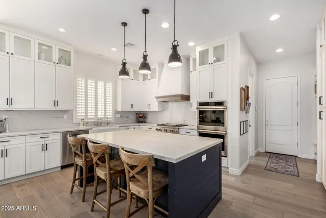 a view of a hallway with white walls and cabinets