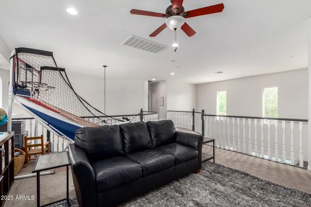 a bedroom with furniture and a flat screen tv