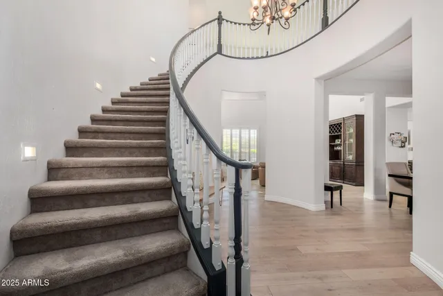 a living room with furniture a window and a potted plant