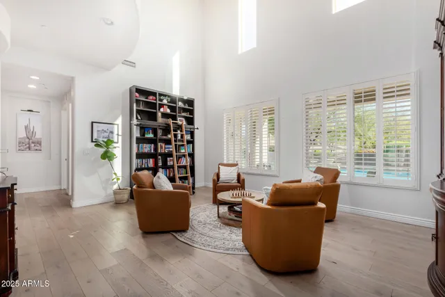 a kitchen with a table chairs and white cabinets