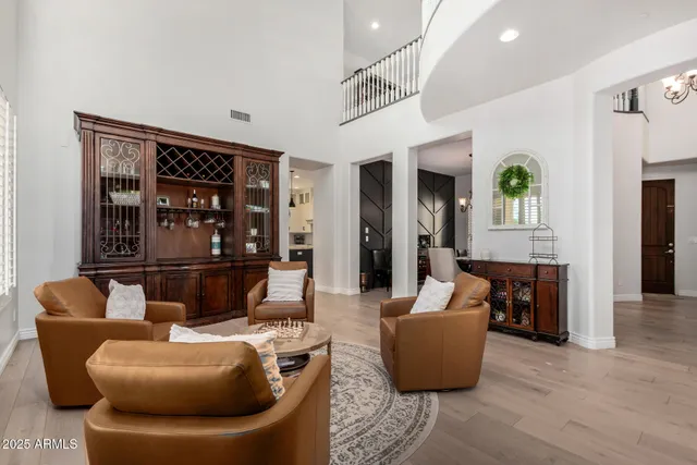 a kitchen with a stove center island chandelier and a living room view
