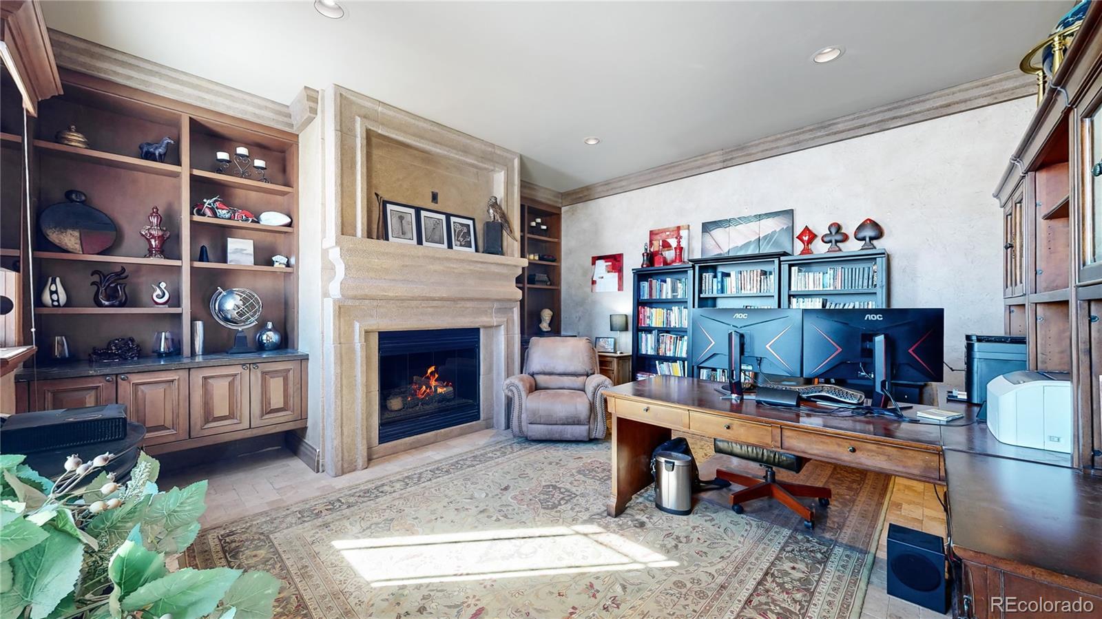 7755 North Moore Road Littleton, CO 80125 - Photo 16 of 46 a living room with furniture a bookshelf and a fireplace