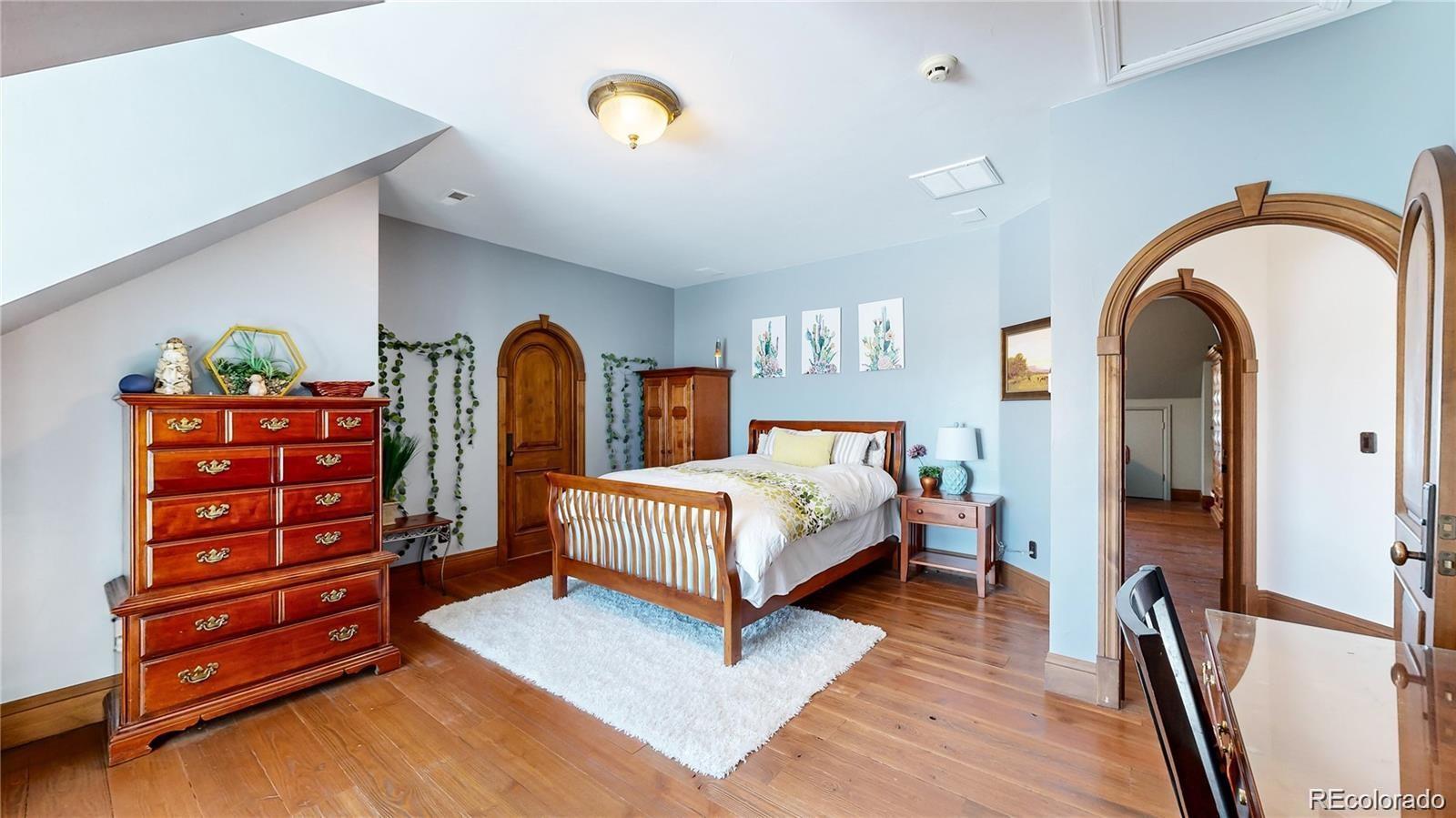 7755 North Moore Road Littleton, CO 80125 - Photo 22 of 46 a bedroom with a bed and a dresser