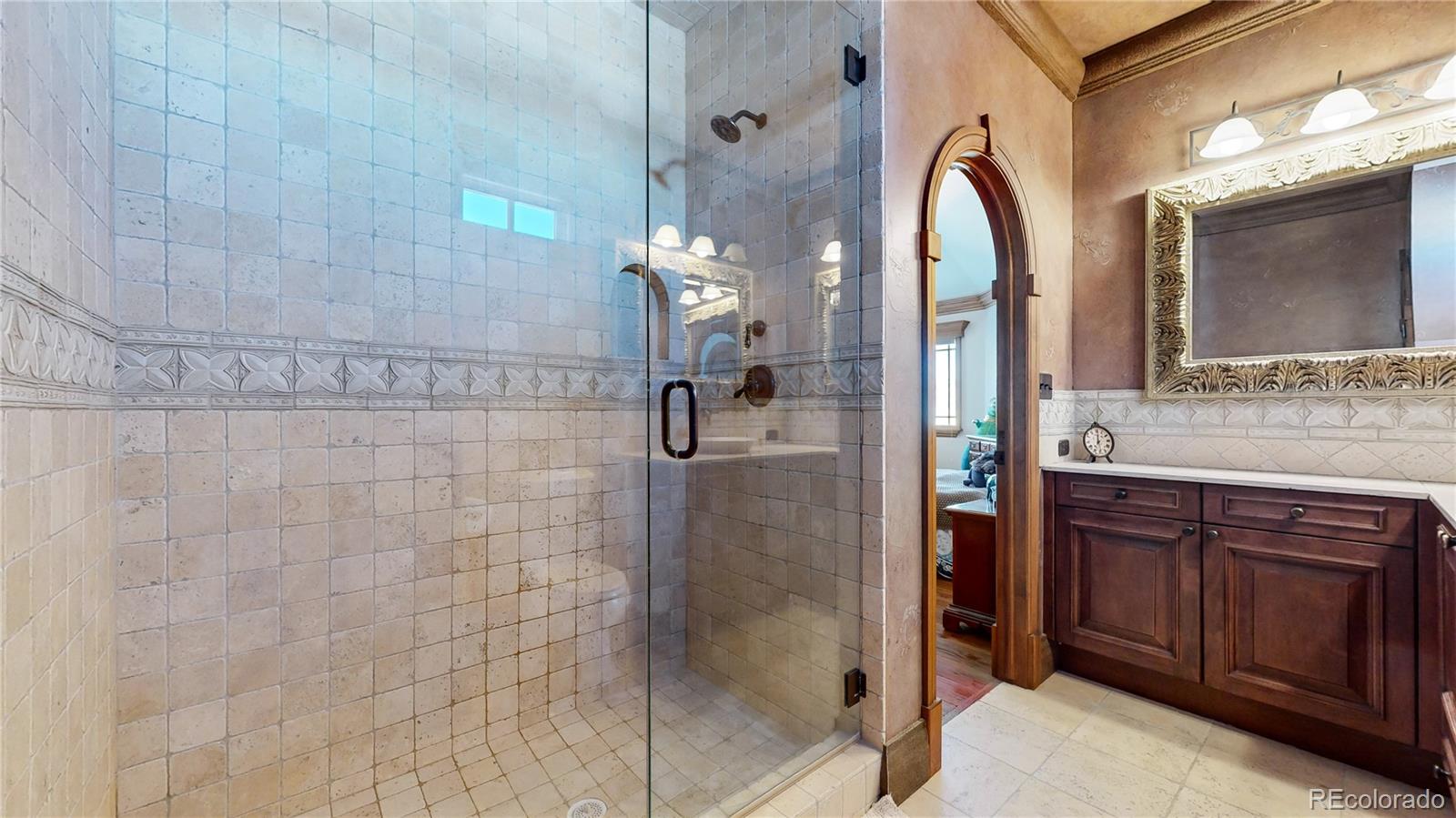 7755 North Moore Road Littleton, CO 80125 - Photo 24 of 46 a bathroom with a double vanity sink mirror and shower