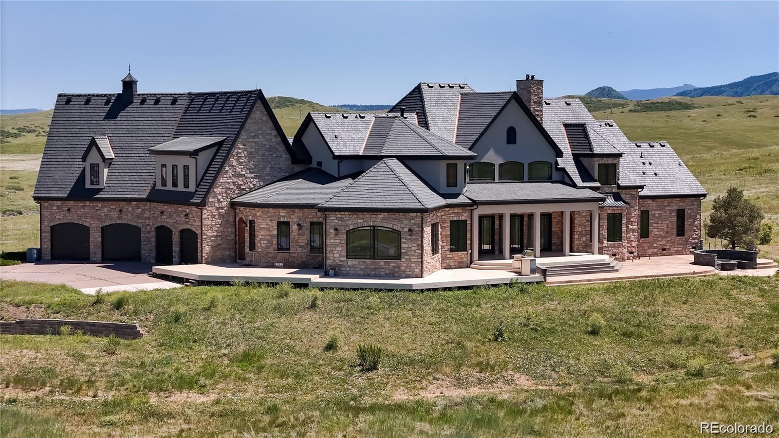 7755 North Moore Road Littleton, CO 80125 - Photo 40 of 46 a front view of a house with a garden