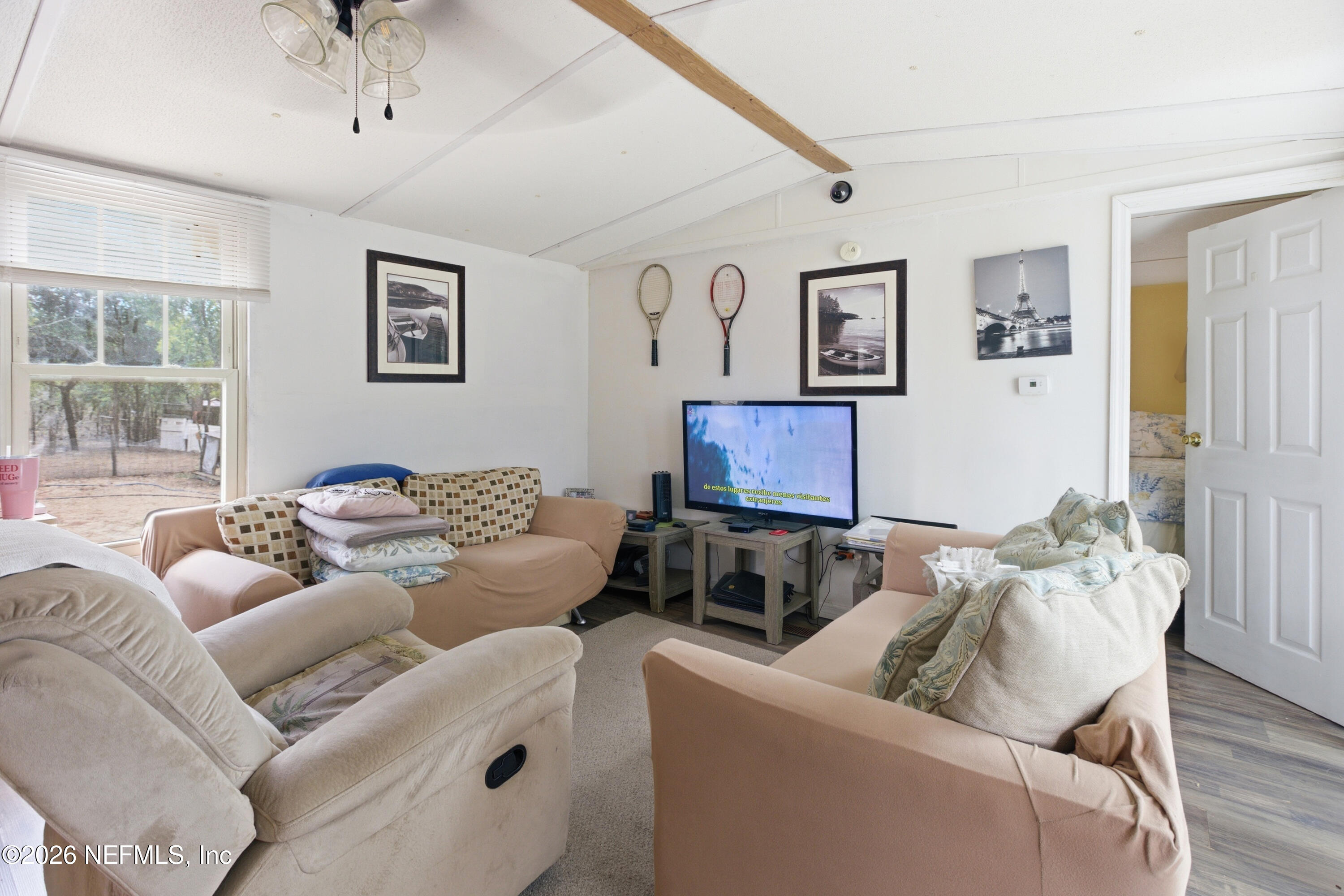 116 London Avenue Interlachen, FL 32148 - Photo 9 of 25 a living room with furniture and a flat screen tv