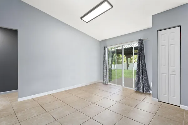 a view of an empty room with glass door