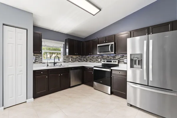 a kitchen with a refrigerator and a sink
