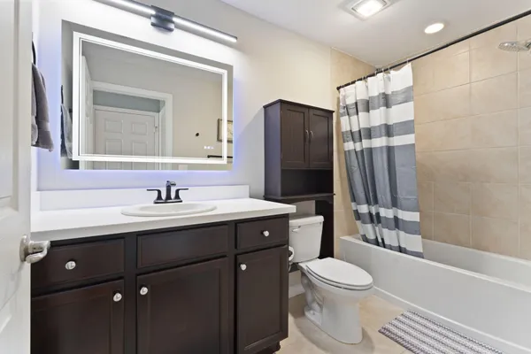 a bathroom with a sink toilet a mirror and shower