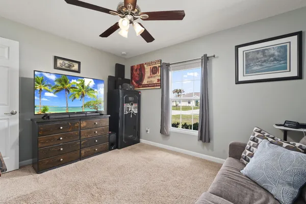 a bedroom with furniture and a flat screen tv