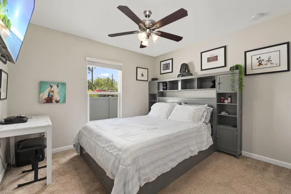 a bedroom with a bed and a desk