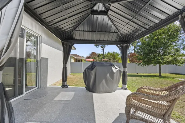 a view of a porch with furniture and a yard