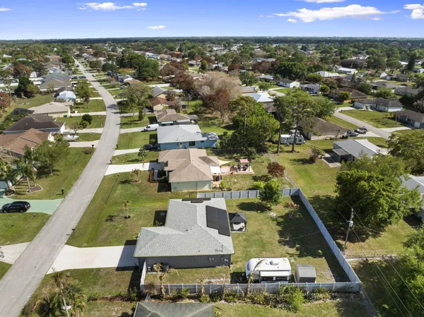 an aerial view of residential houses with outdoor space and swimming pool