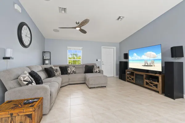 a living room with furniture a large window and a flat screen tv