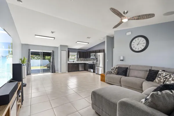 a living room with furniture and kitchen view
