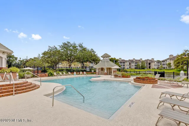 a view of a swimming pool and lounge chair