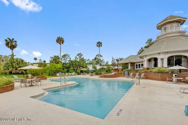 a view of a swimming pool with outdoor seating