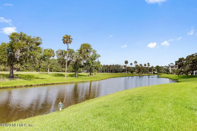 a view of a lake with houses in the background