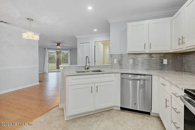 a kitchen with granite countertop white cabinets and white appliances