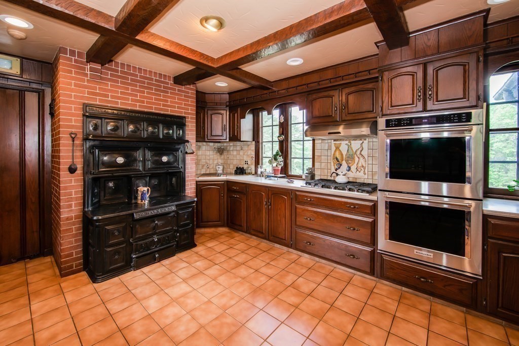 17 Longview Road Reading, MA 01867 - Photo 14 of 42 a kitchen with stainless steel appliances kitchen island granite countertop a refrigerator and a stove top oven