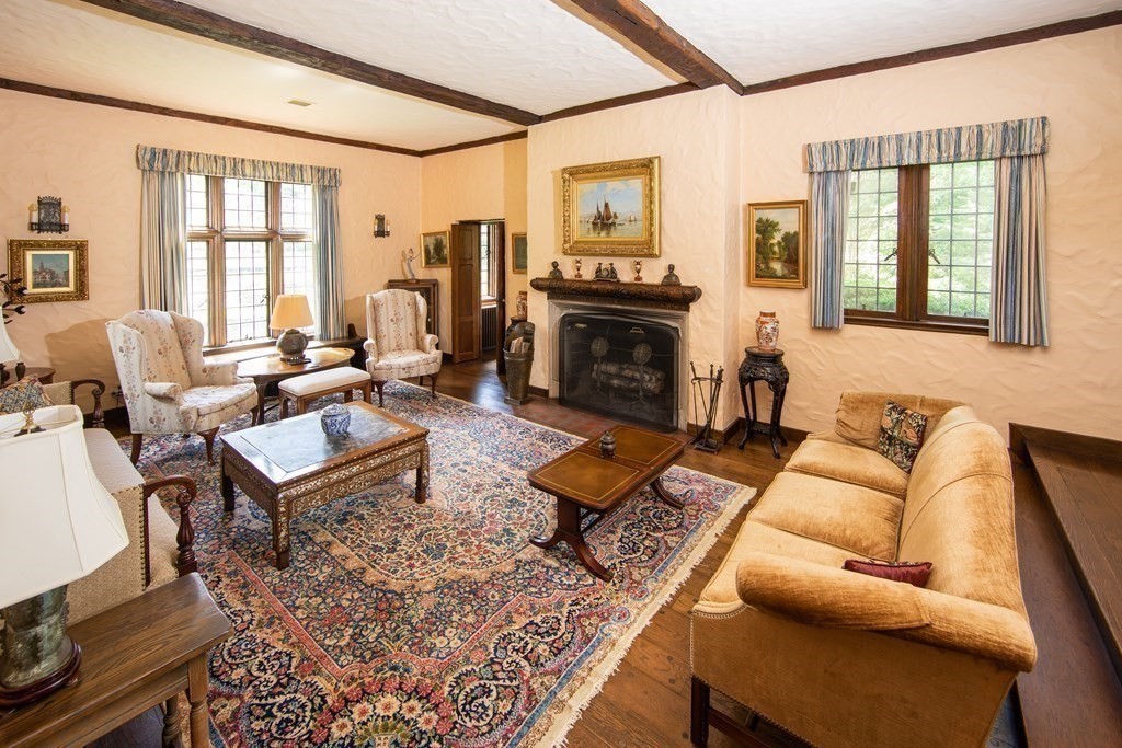 17 Longview Road Reading, MA 01867 - Photo 17 of 42 a living room with furniture fireplace and a table