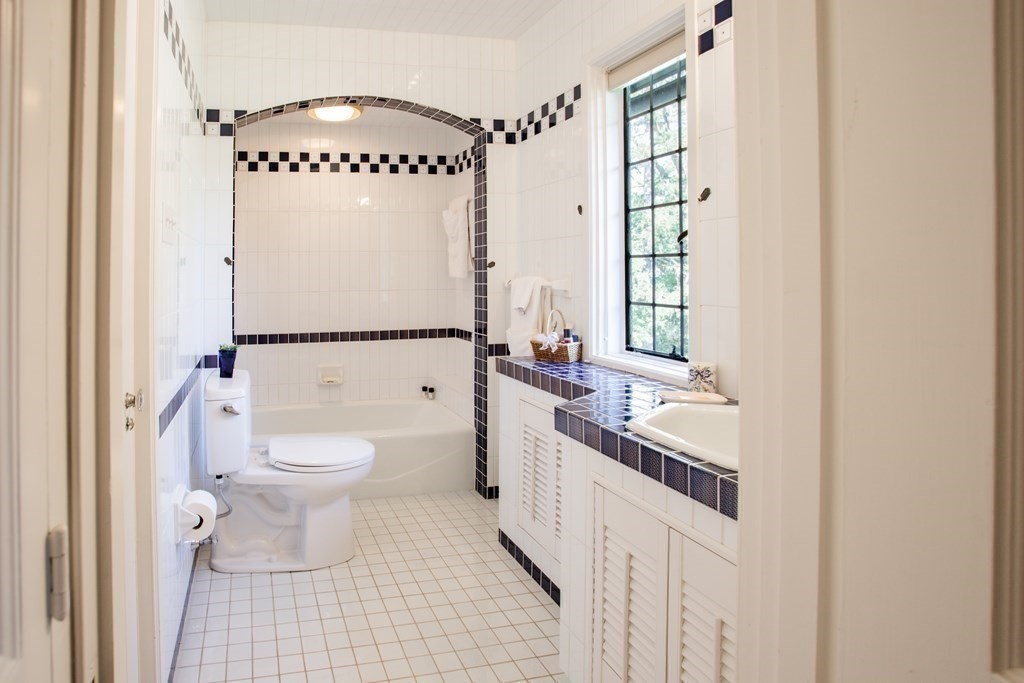 17 Longview Road Reading, MA 01867 - Photo 30 of 42 a bathroom with a granite countertop sink mirror vanity and toilet