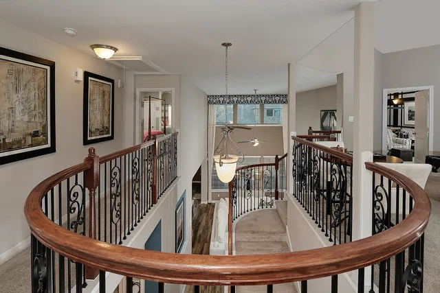 a view of staircase and living room with wooden floor