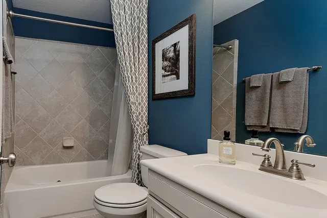 a bedroom with a bed couch and a window