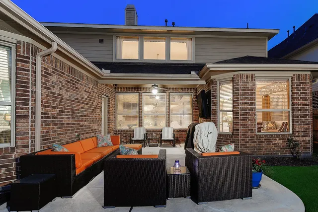 a backyard of a house with table and chairs