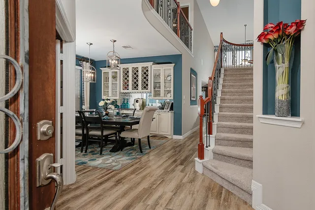 a view of a livingroom with furniture a dinning table and chairs