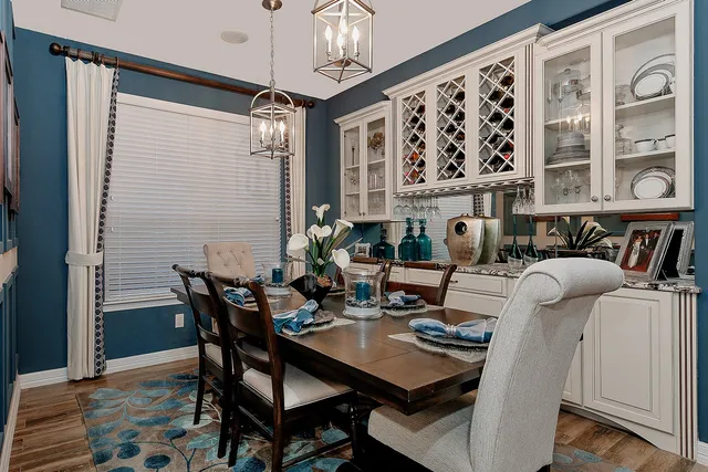 a view of a dining room with furniture and chandelier