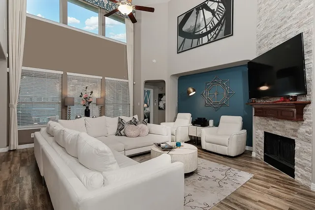 a living room with fireplace furniture and a flat screen tv