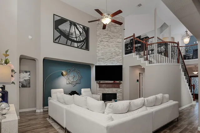 a living room with furniture a fireplace and a flat screen tv