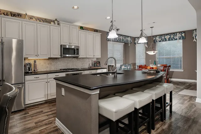 a kitchen with kitchen island a sink counter space and stainless steel appliances