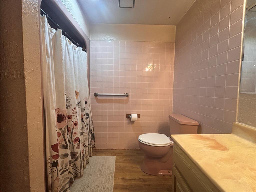 5355 Banks Road Fort Worth, TX 76140 - Photo 5 of 29 a bathroom with a granite countertop sink toilet and shower