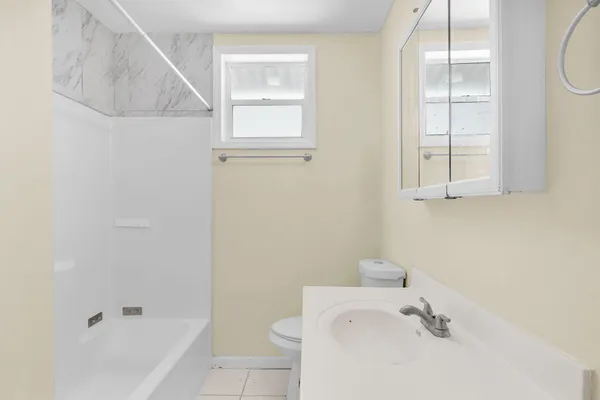 a bathroom with a bathtub sink and toilet