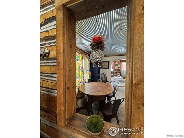 a dining room with furniture and a potted plant