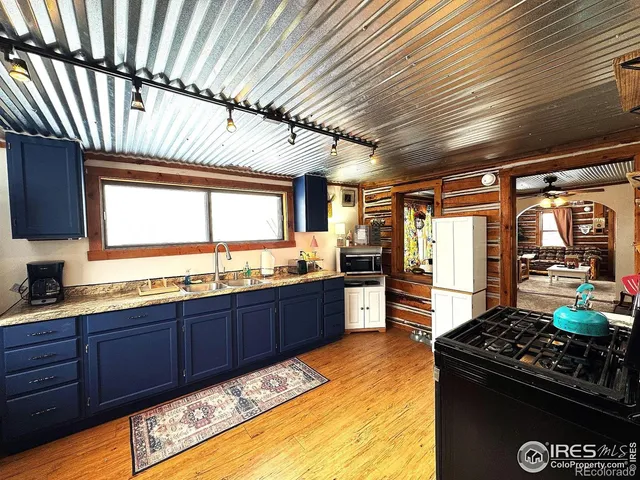a kitchen with stainless steel appliances granite countertop a sink stove and cabinets