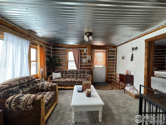 a living room with furniture and large windows