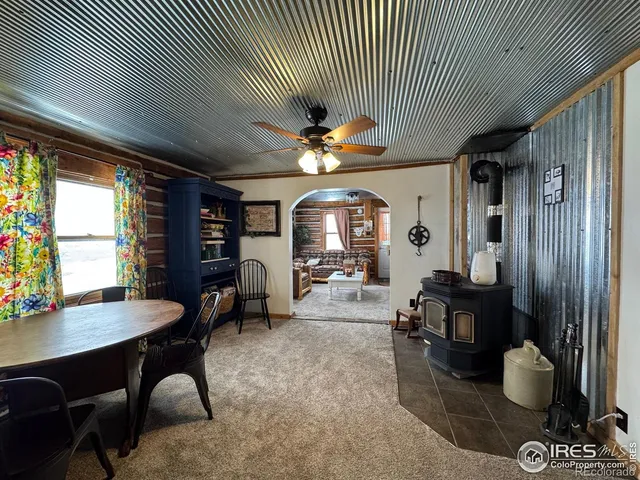 a living room with furniture a chandelier and a large window